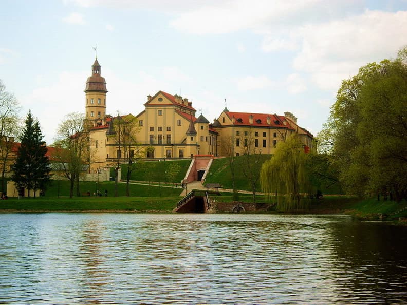 Nesvizh Castle and its formal gardens reflected in the surrounding lakes