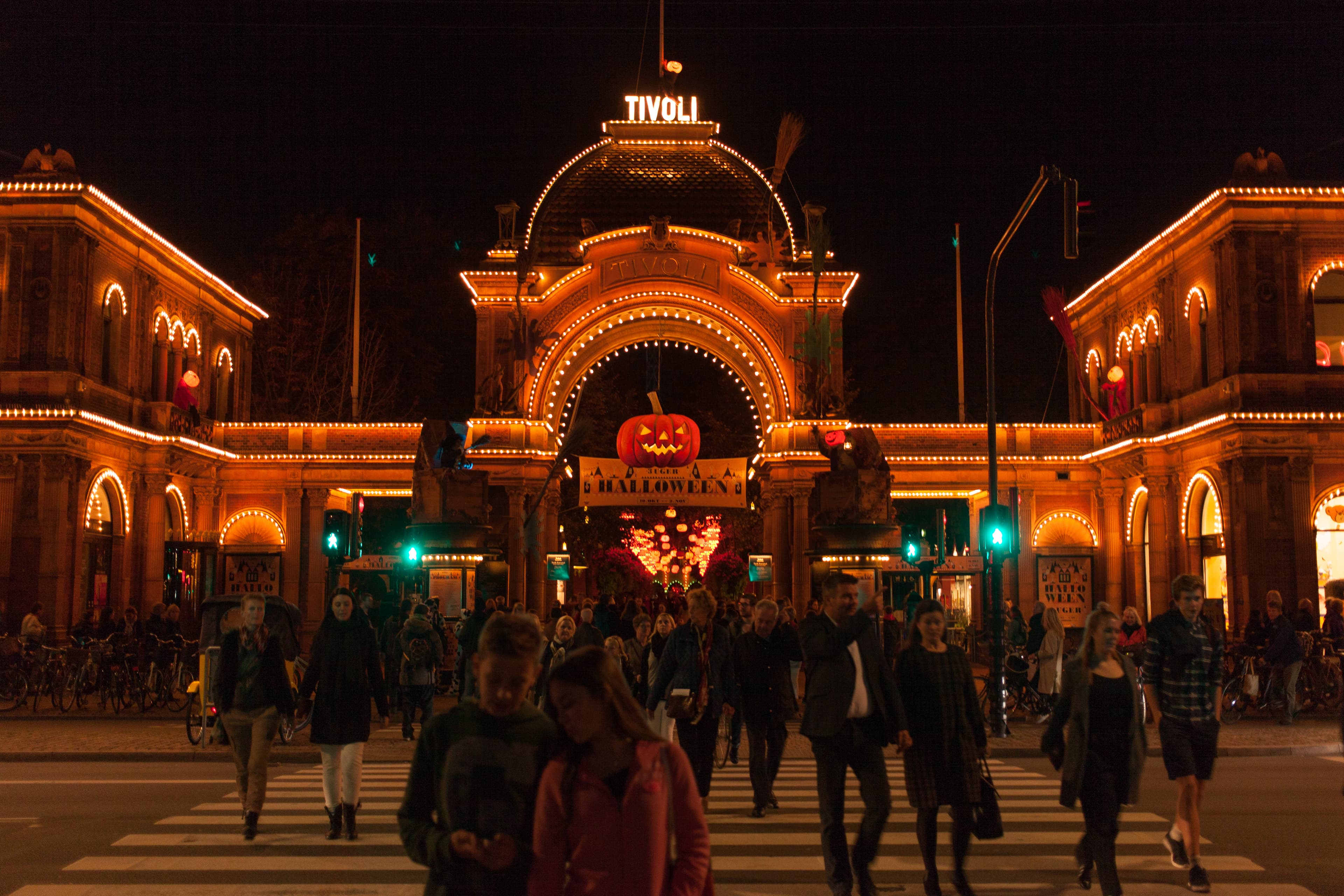 Twinkling lights and rides at Tivoli Gardens in Copenhagen at dusk