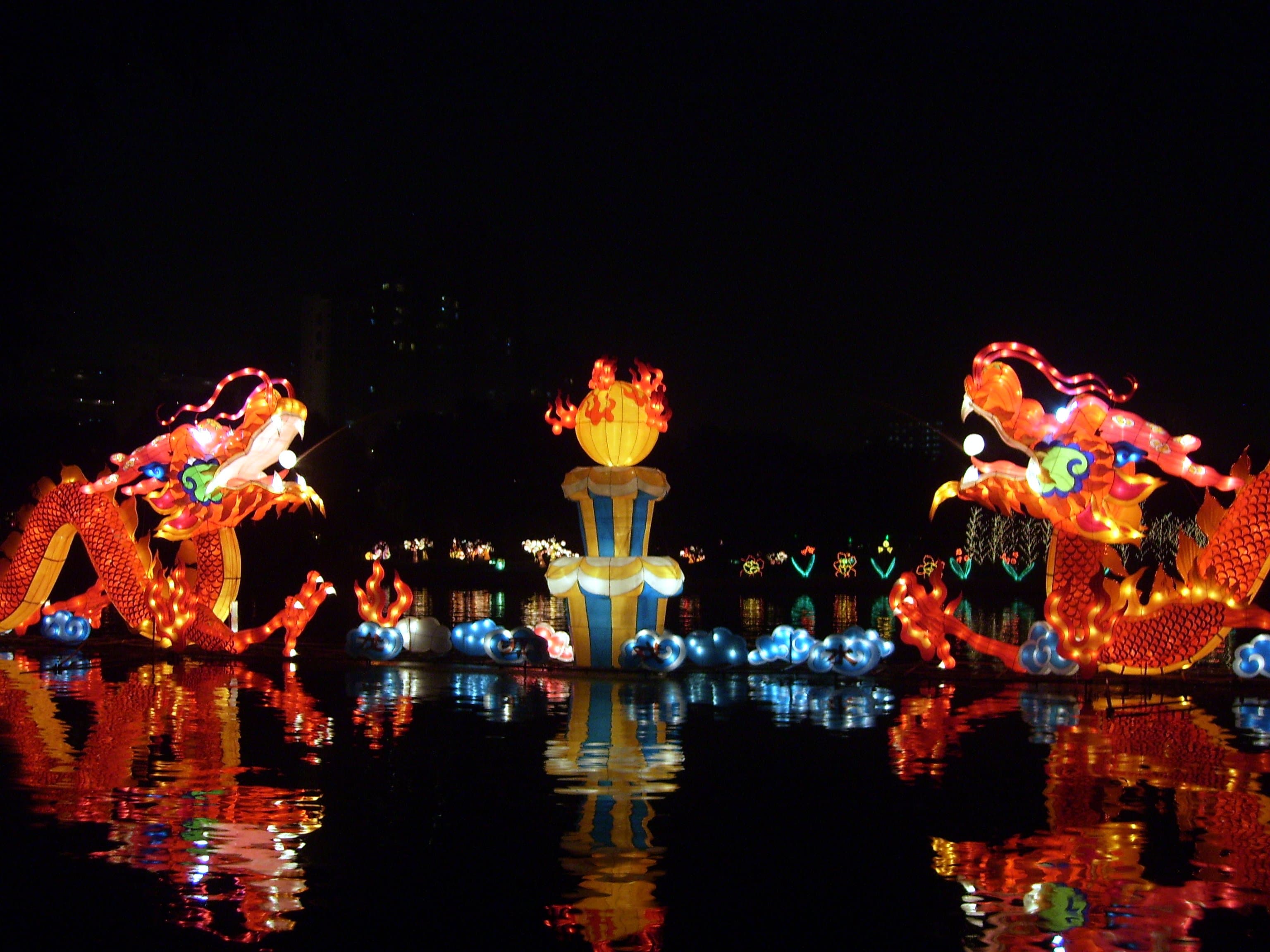 Children carrying glowing lanterns at night during the Mid-Autumn Festival in Hong Kong