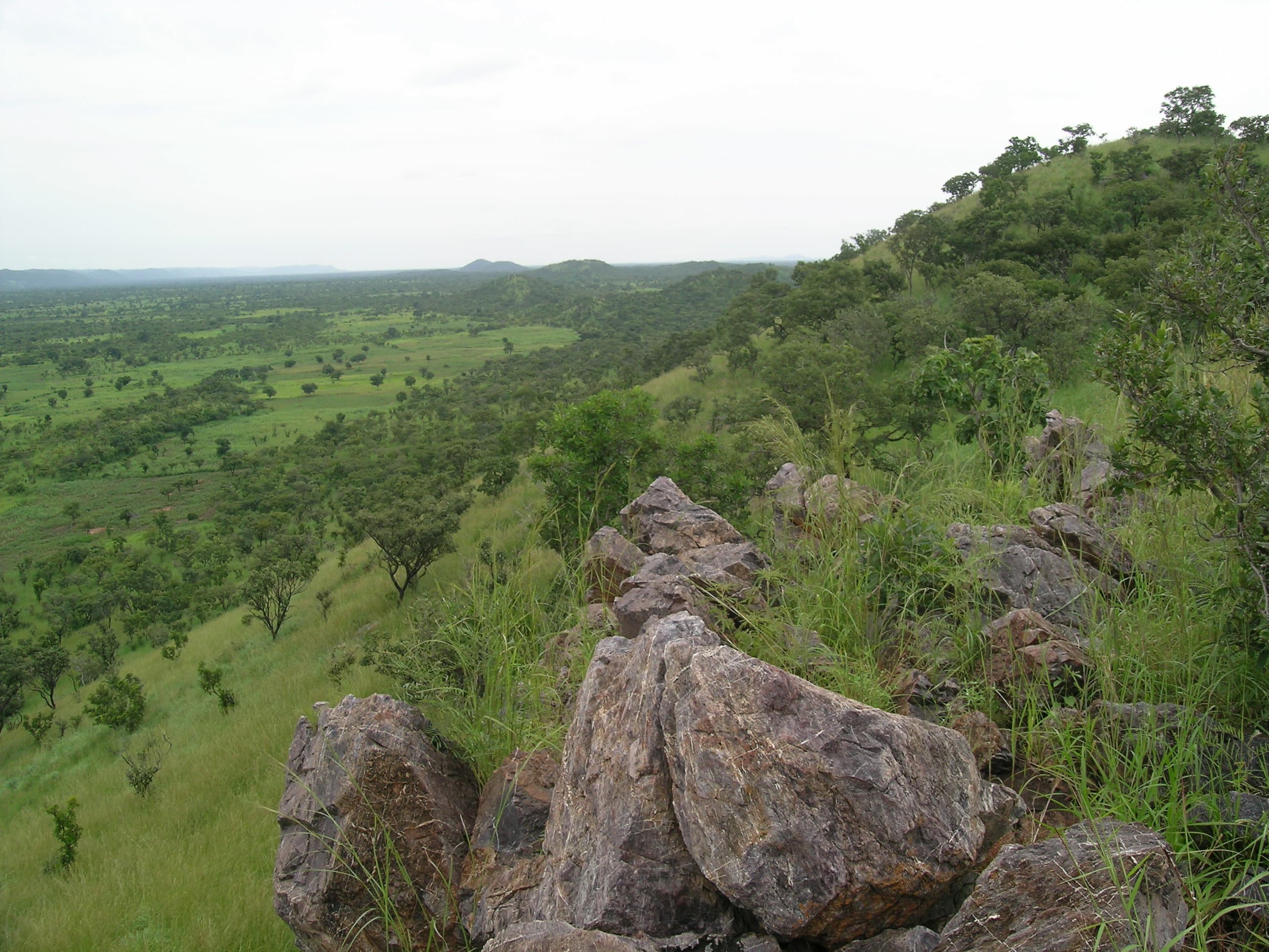 Rolling green hills and rocky peaks of the Atakora Mountains in northern Benin