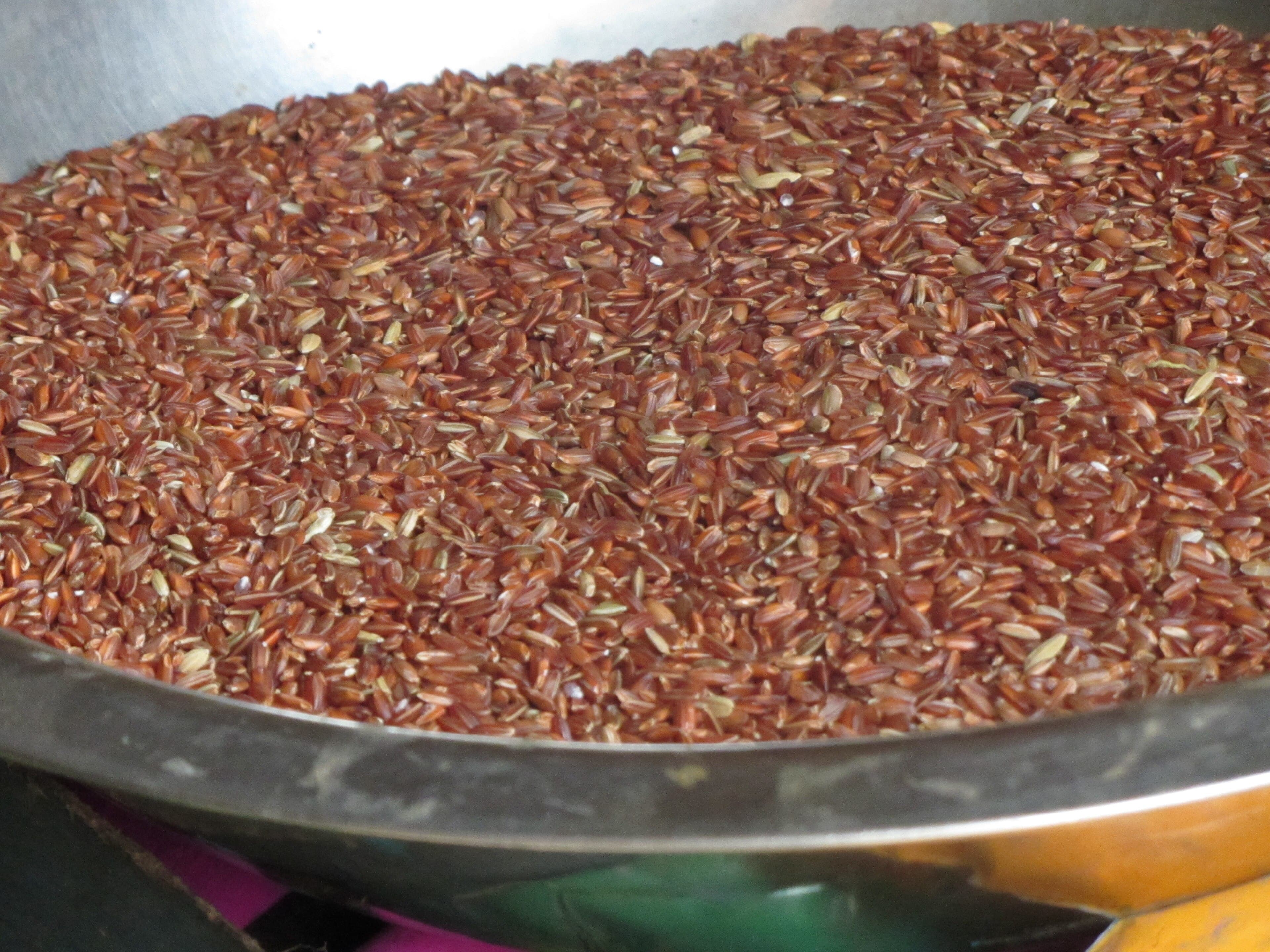 A bowl of cooked Bhutanese red rice with a reddish-brown colour and fluffy texture
