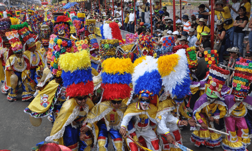 Colourful costumed dancers and musicians parading through the streets of Barranquilla
