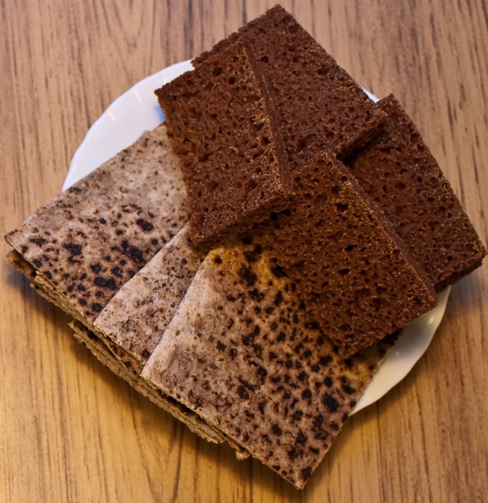 A loaf of dark Icelandic rúgbrauð sliced and topped with butter