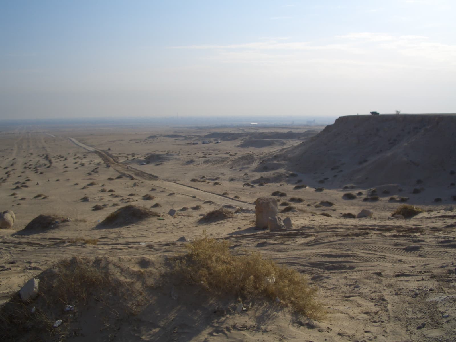 Rocky escarpment at Mutla Ridge overlooking a flat sandy Kuwaiti landscape