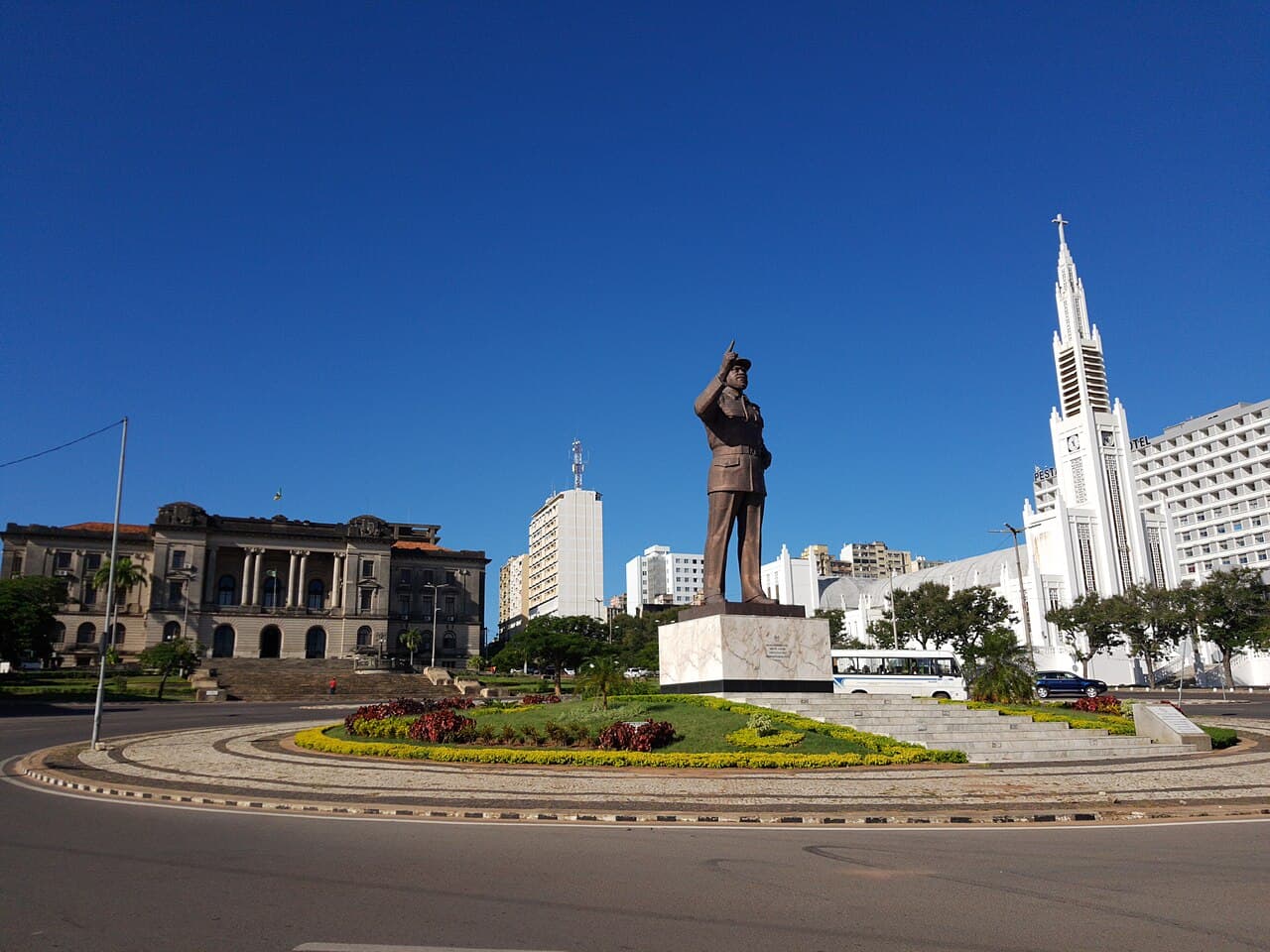 Crowds celebrating Mozambique Independence Day with flags and colourful costumes in a city square