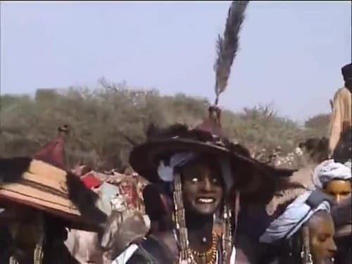 Tuareg women playing tindé drums at a night gathering under the stars