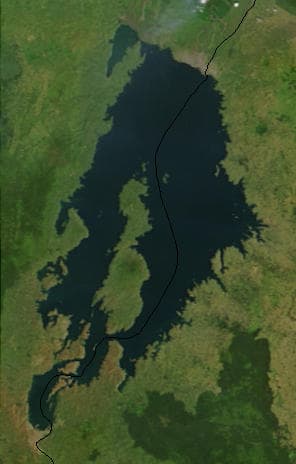 The blue waters of Lake Kivu seen from a green Rwandan hillside