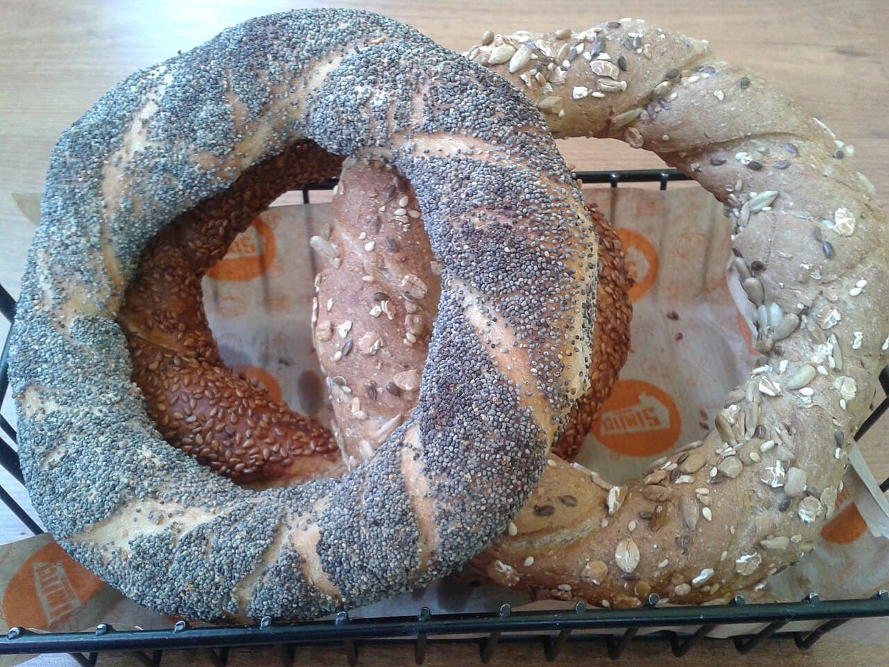 A pile of sesame-coated simit bread rings on a red Turkish street cart