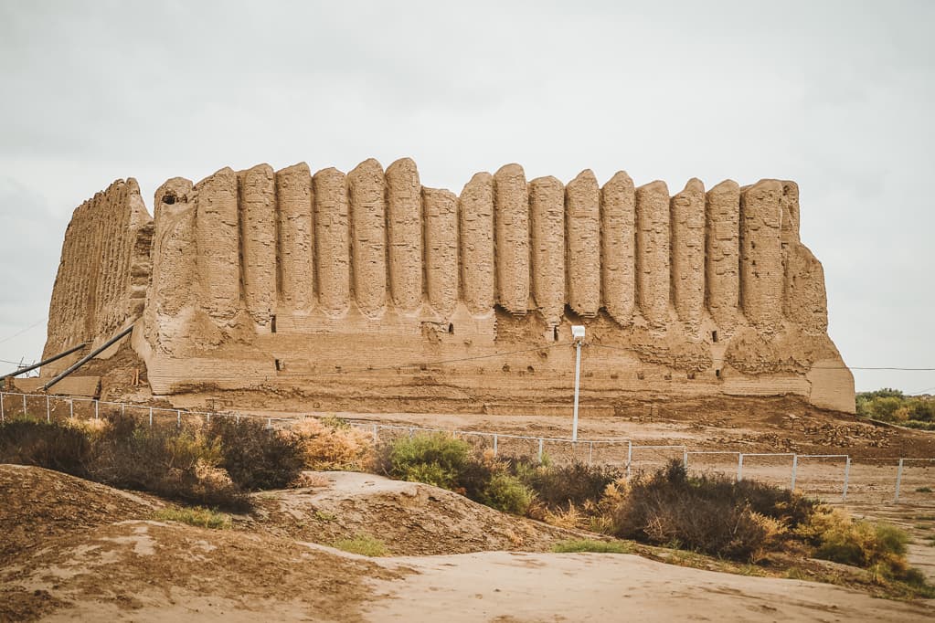 The ancient mud-brick ruins and domed mausoleums of Merv stretching across flat desert